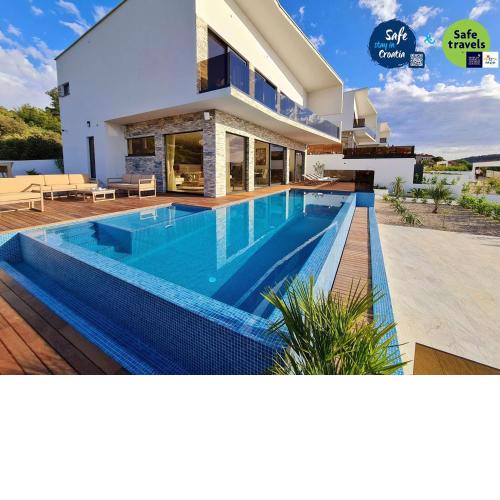 Villa Ramarin III with infinity heated pool, jacuzzi and sauna by the sea in Rogoznica